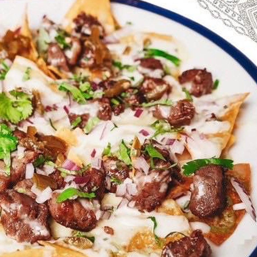 Beef nachos with cheese, onion and coriander