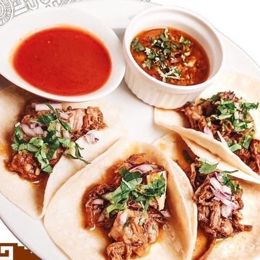 Birria tacos with consomé and red salsa