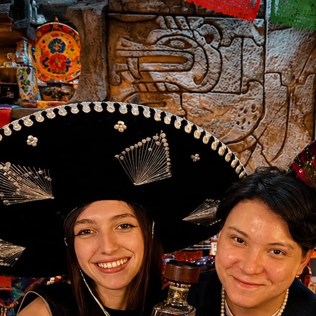 Guests in sombreros at the carved stone wall